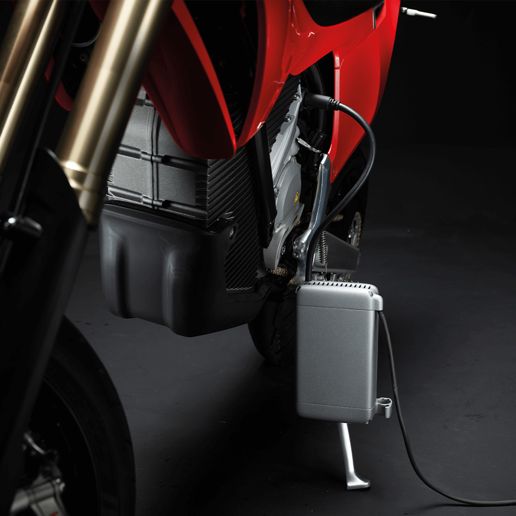 Stark VARG SM 60 PS in Stark Red beim Laden mit angeschlossenem Ladegerät